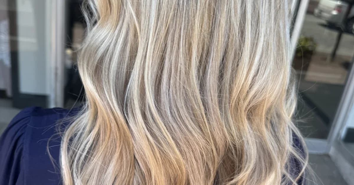 Butter blonde balayage with seamless beach waves showcasing premium hairstylist work by Brooke Holland
