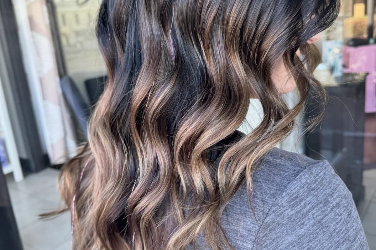 Dark brown caramel balayage with rich dimension on long wavy hair by Brooke Holland showing premium pricing quality